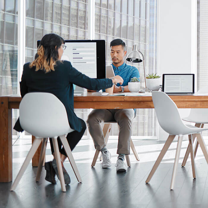 man and woman working at desk in office