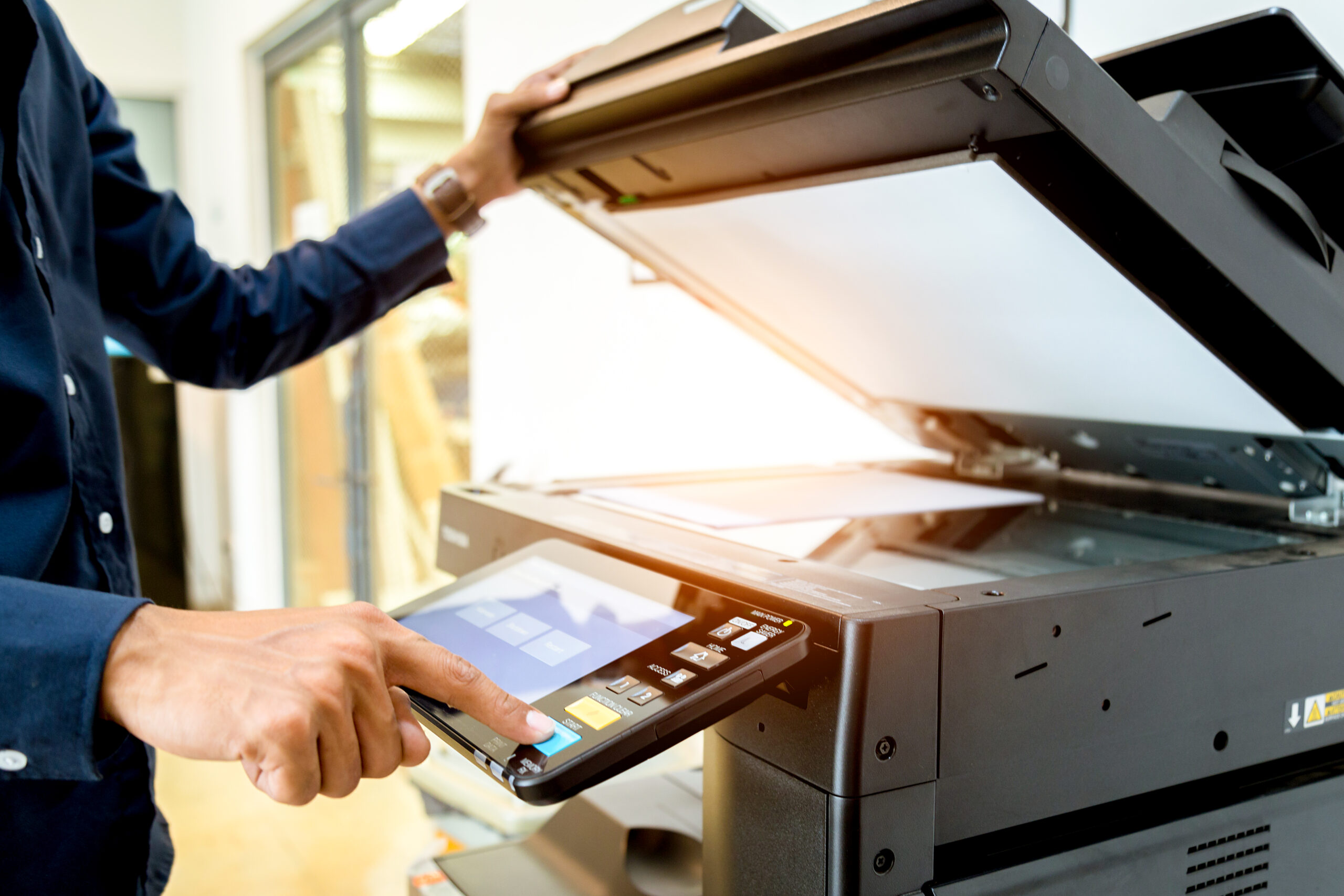Business man Hand press button on panel of printer, printer scanner laser office copy machine supplies start concept.