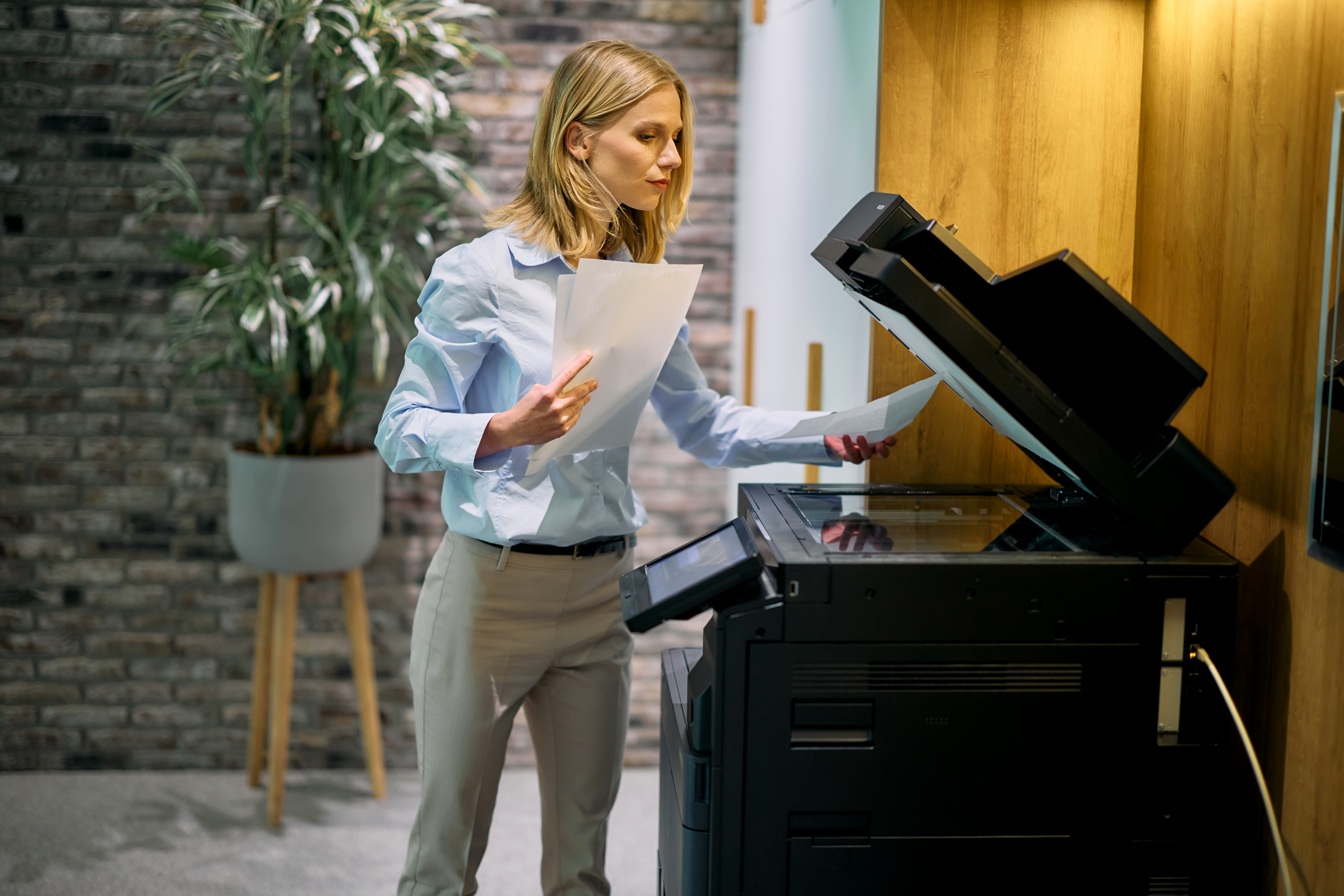 Businesswoman making photocopies in the office